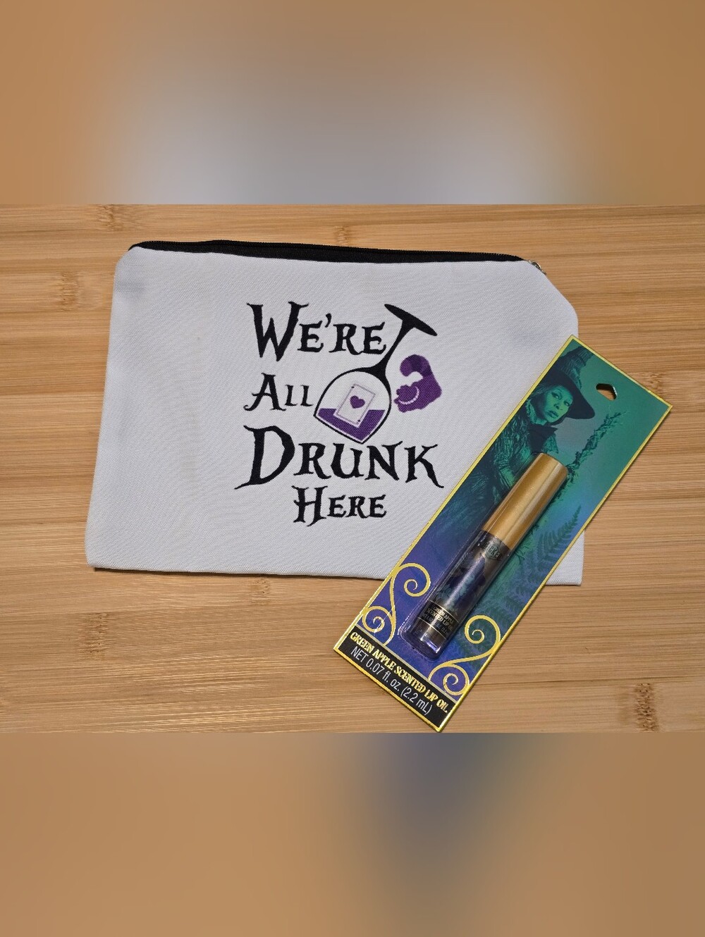 Wicked Movie Green Apple Scented Lip Oil & Were All Drunk Here Canvas Makeup bag